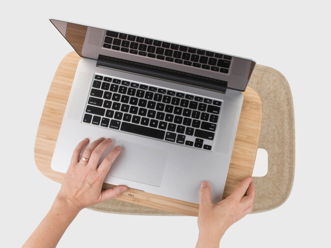 Reaching in sustainable felt cushion organiser of Oatmeal or Ash Grey Lapod Lap Desk, Objct Co design, Macbook pro on tray