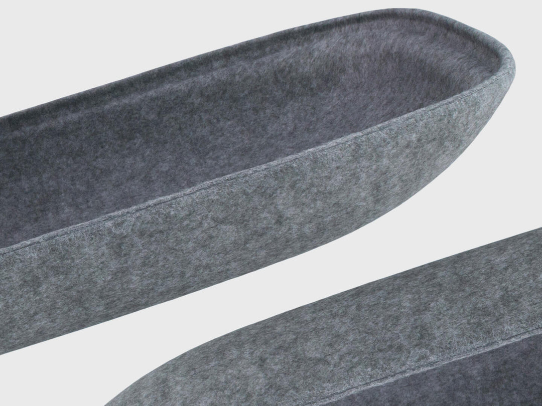 Detail of 2 ash grey or charcoal felt storage cushions for Lapod lap desk made in sustainable recycled PET material hovering